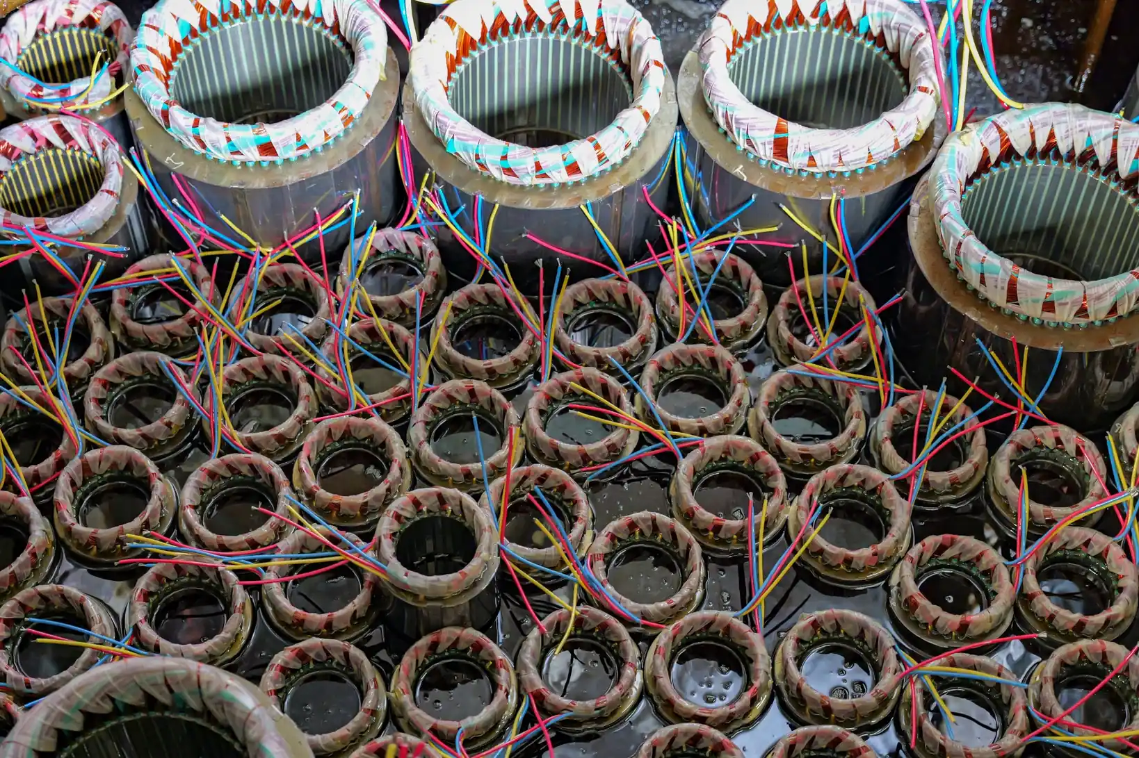 Electric motor stator winding coils with colored wires during motor production